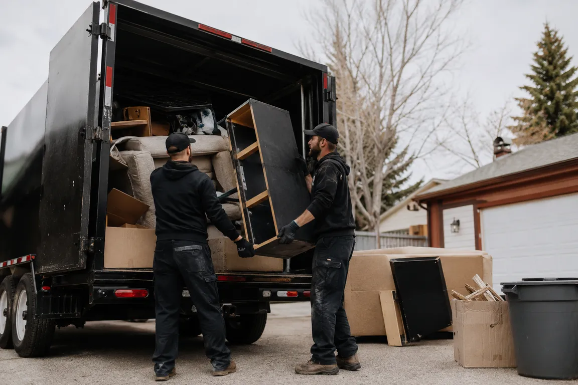 Junk removal crew cleaning a residential property in Calgary