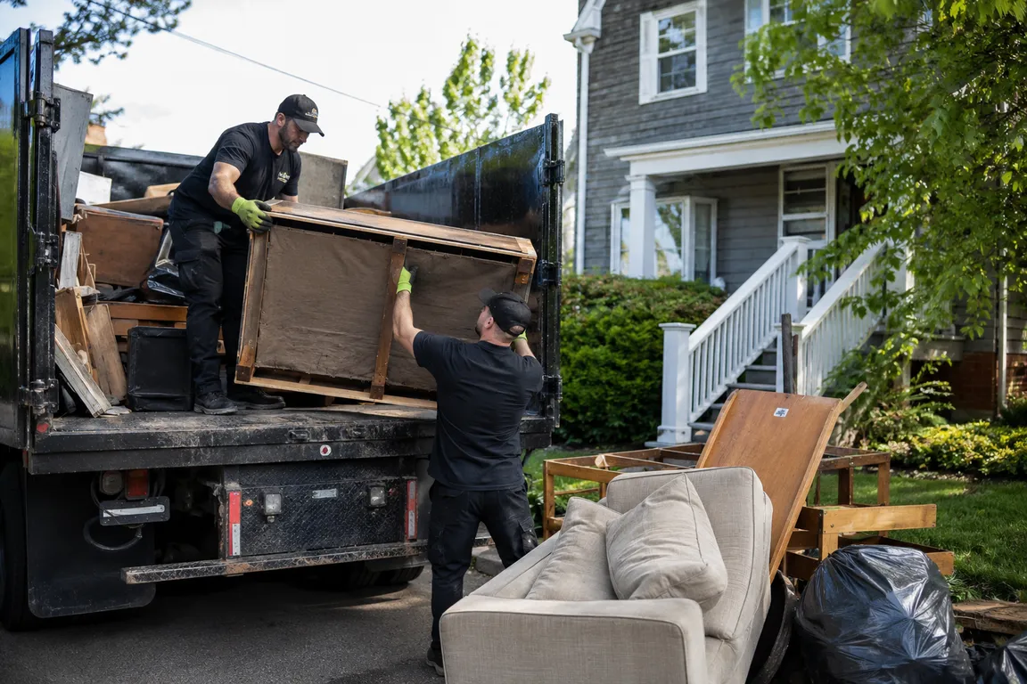 Junk removal crew cleaning a residential property in Kentville