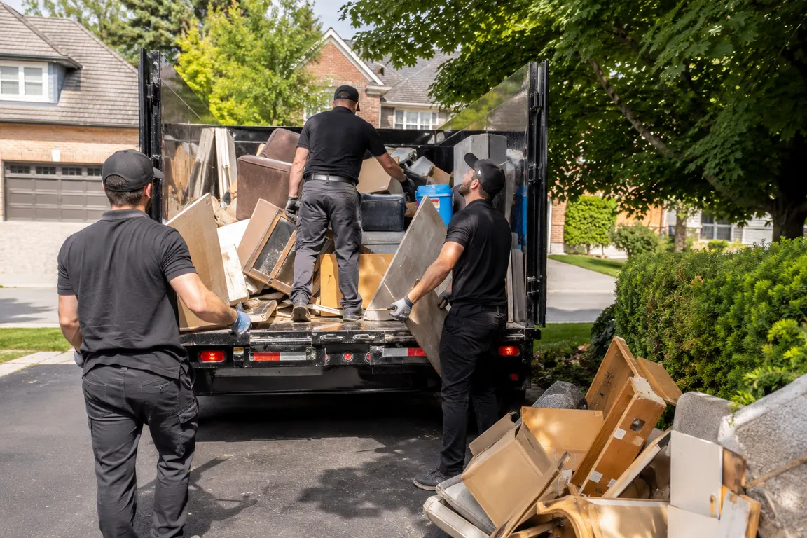 Junk removal crew cleaning a residential property in Richmond Hill