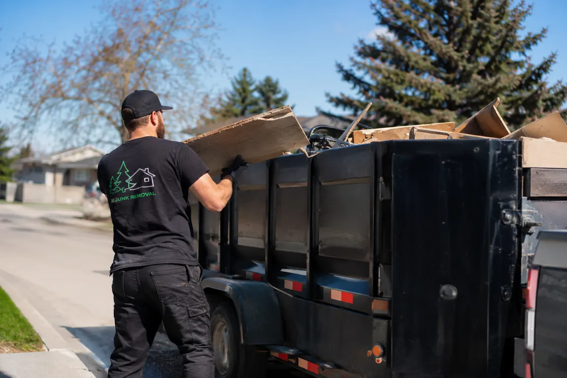 Junk removal crew cleaning a residential property in Steinbach