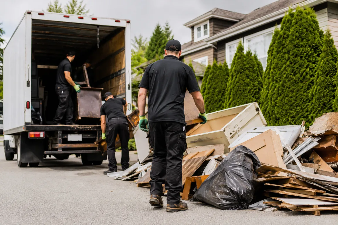 Junk removal crew cleaning a residential property in Surrey