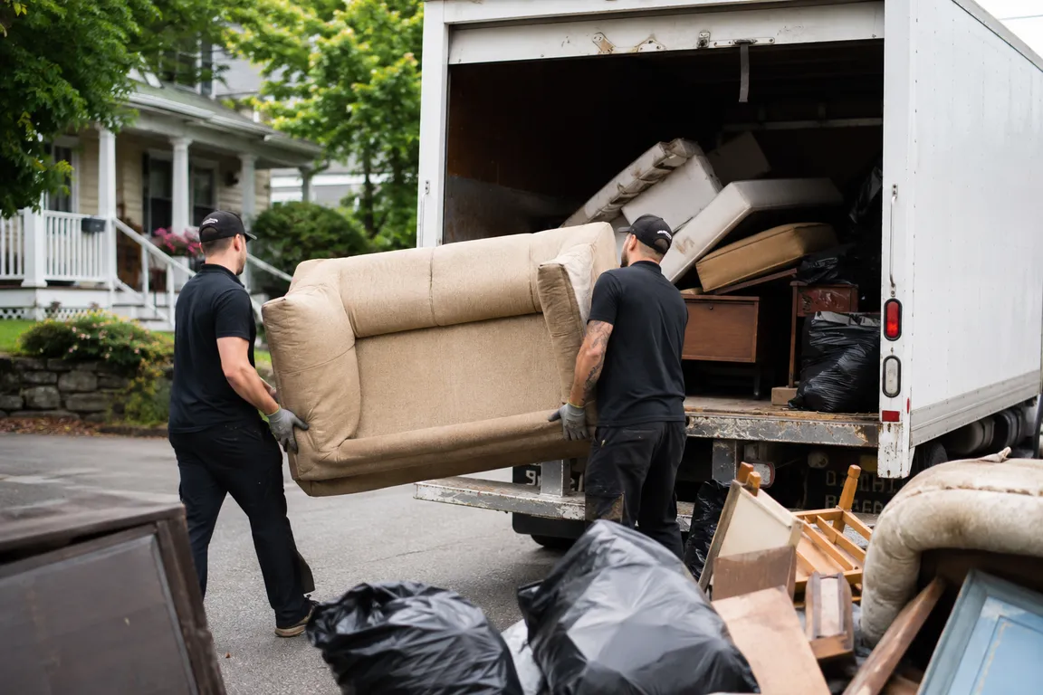 Junk removal crew cleaning a residential property in Victoria
