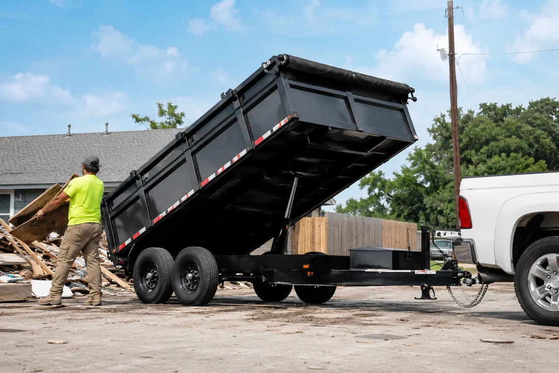 Crew loading debris into a dump trailer during cleanup